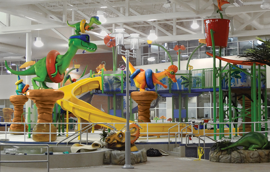 Fun kids water park with colorful dinosaur sculptures and themed décor